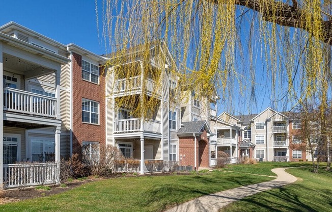 a row of apartments with balconies and a sidewalk