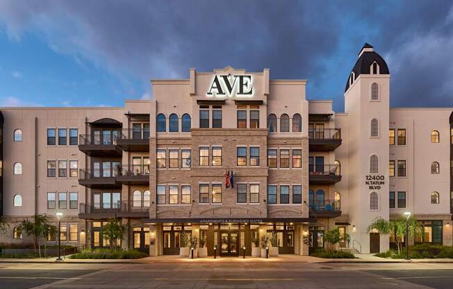 The hotel is called AVE and it is a large building with many windows.