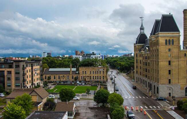 A street view of a city with buildings and cars.