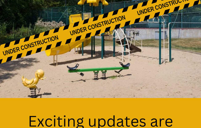 A playground with a yellow rubber duck and a caution tape that reads "UNDER CONSTRUCTION".