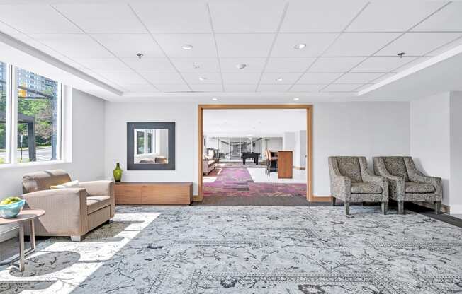 a living room with couches and chairs and a rug