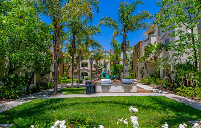 A sunny day in a well-maintained garden with white flowers and greenery.