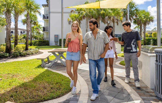 A group of people walking in a park-like setting.