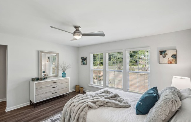 a bedroom with a large bed and a ceiling fan