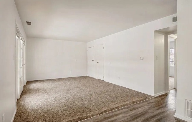 a room with a carpeted floor and white walls