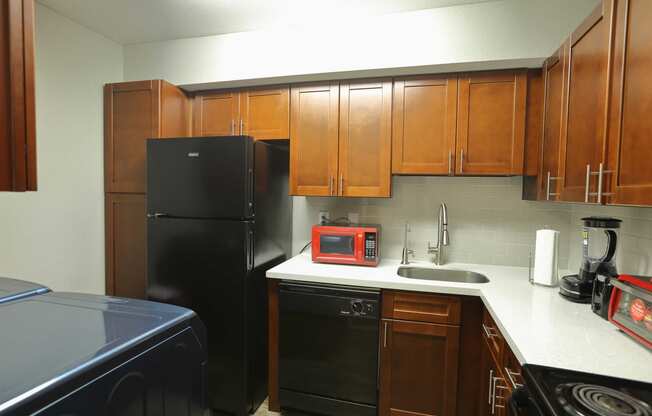 kitchen with white counters and black appliances