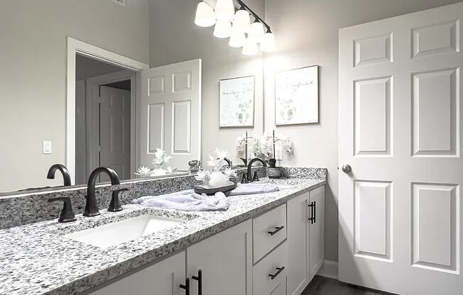 A bathroom with a sink and a mirror.