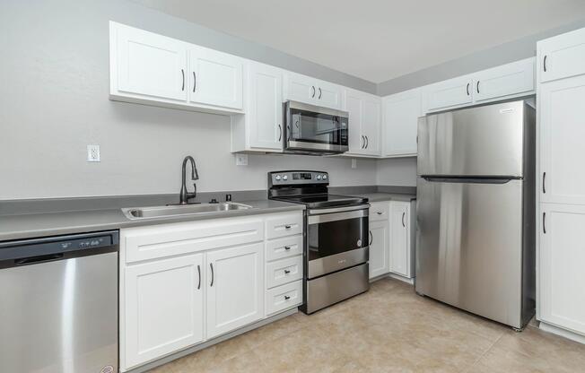 a kitchen with a stove and a refrigerator