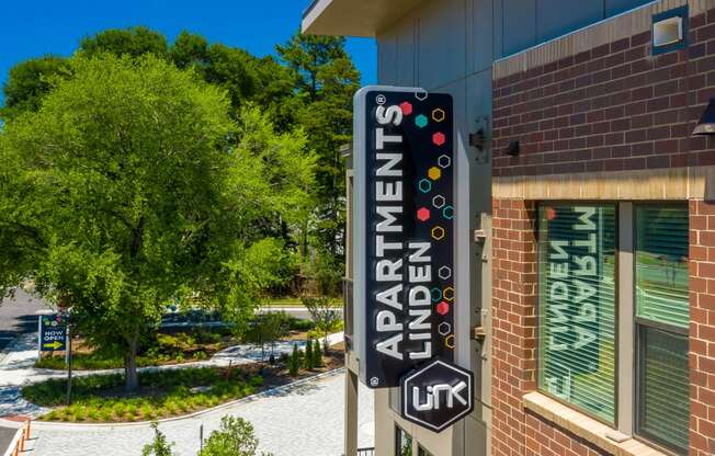 Building sign and trees at Link Apartments® Linden in Chapel Hill, NC