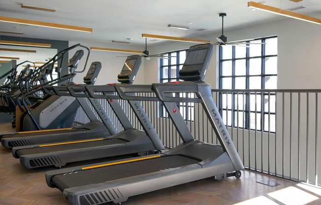 Multiple treadmills and elliptical with stair stepper at Novel Cary