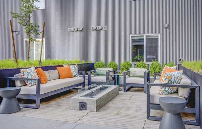 a seating area with couches and chairs on a patio