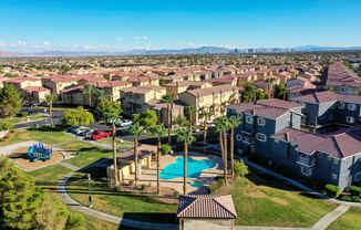 an aerial view of a neighborhood with houses and a swimming pool