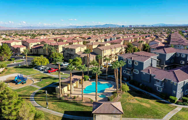 an aerial view of a neighborhood with houses and a swimming pool