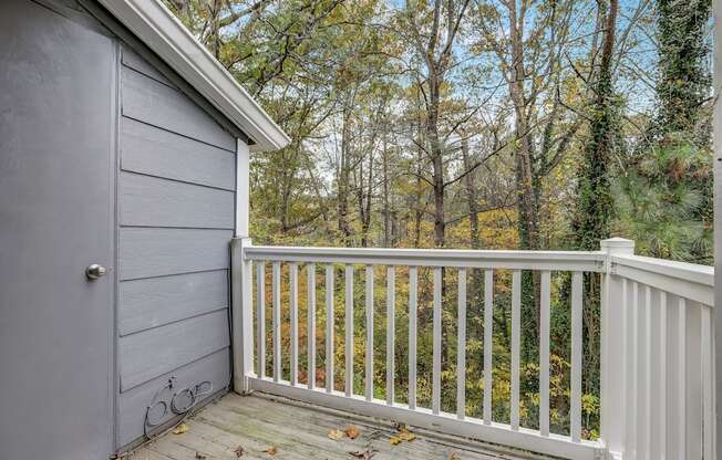 a backyard deck with a garage door and trees