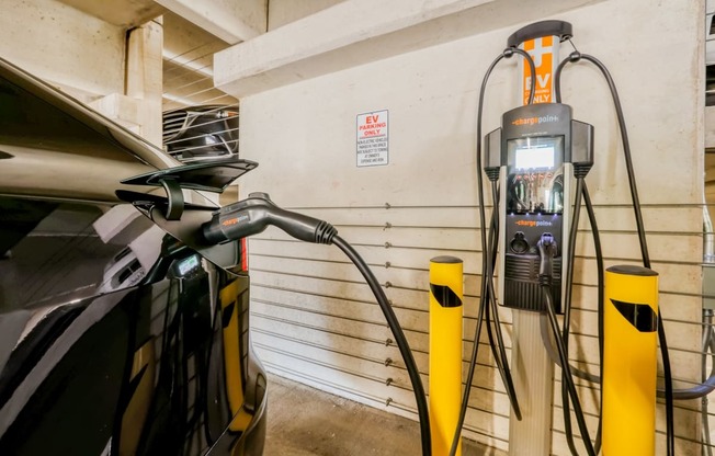 an electric vehicle plugged into a charging station in a garage
