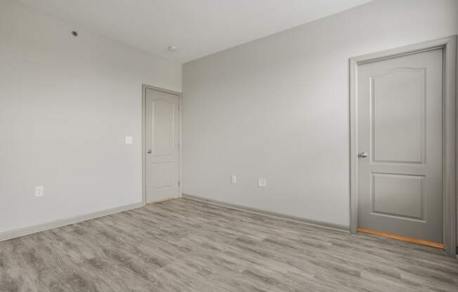 an empty room with a door and a white wall