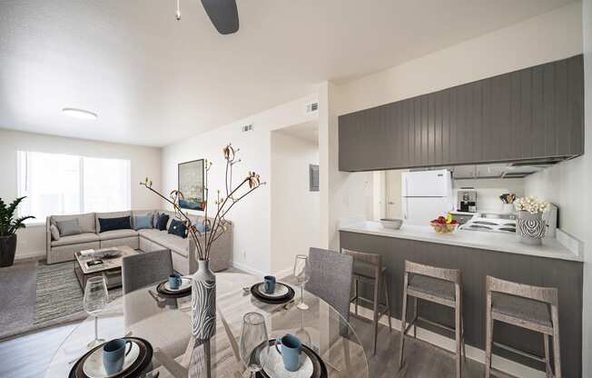 a living room and kitchen with a glass table and chairs at Summit, Pocatello, ID