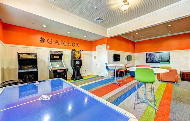 a game room with a ping pong table and arcade games  at Hacienda Club, Jacksonville, 32256