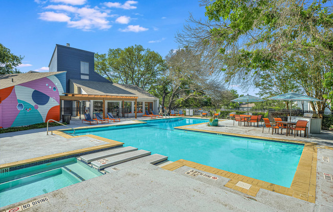 a swimming pool with a house in the background