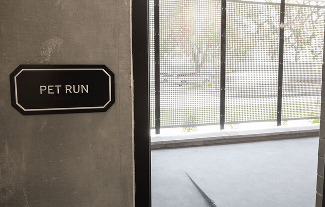 a sign that says pet run on the side of a building at The Landing at 1001 NP, Fargo, ND, 58102