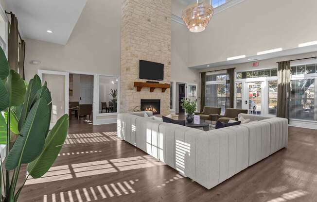 A modern living room with a fireplace and a large couch.