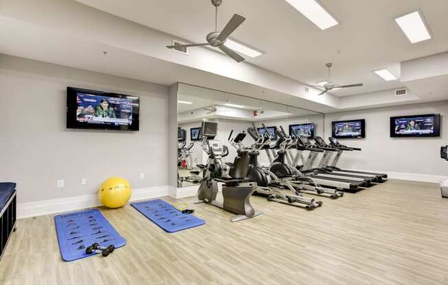 our state of the art gym is full of cardio equipment and televisions