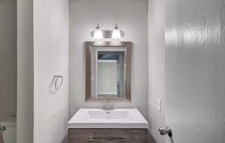 a bathroom with a sink and mirror