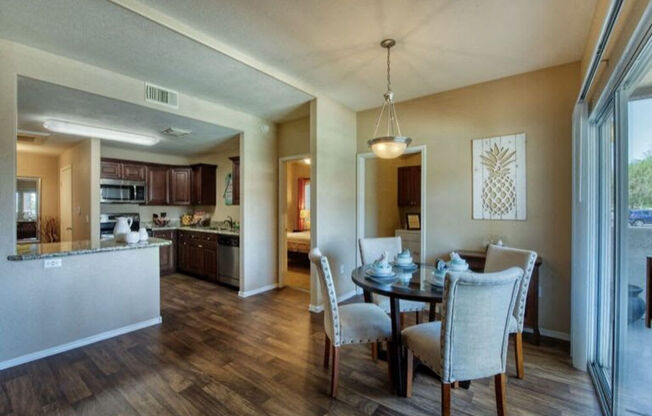 a dining room and kitchen with a table and chairs at Villas on Bell, Arizona