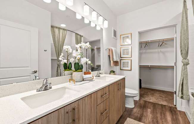 A bathroom with a white sink and a white toilet.