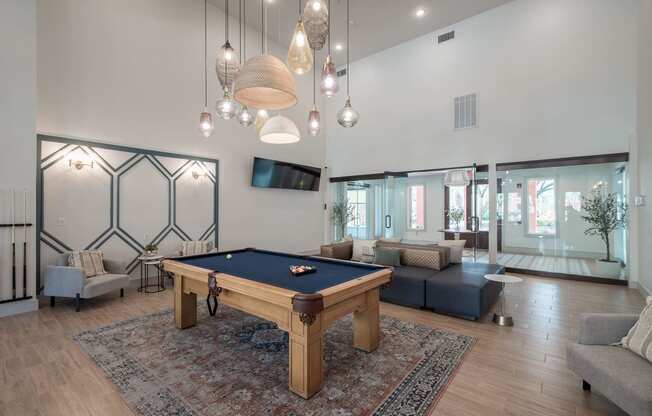 a living room with a pool table in the center