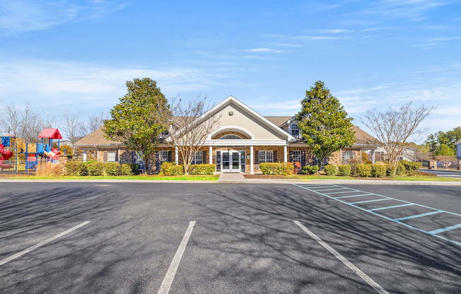 A large building with a parking lot in front of it.