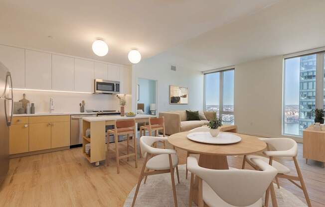A modern kitchen with a dining table and chairs.