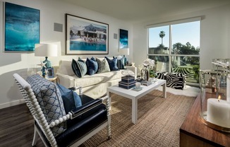 A living room with a white sofa and a large window.
