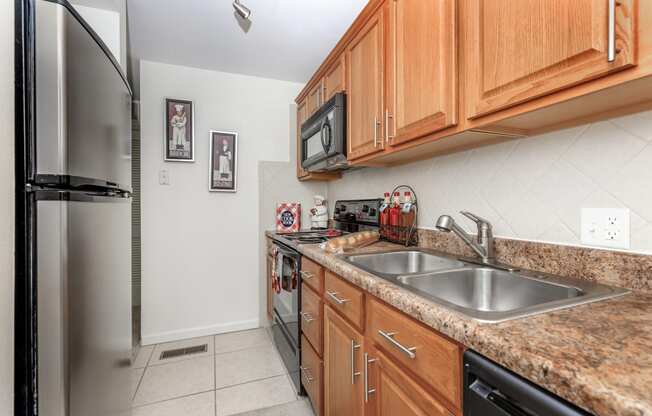 the kitchen has granite countertops and stainless steel appliances