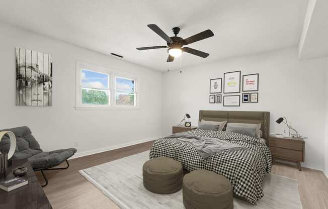 a bedroom with a bed and a ceiling fan