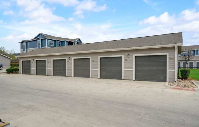 a garage with four doors in front of a house