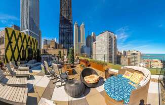 a rooftop patio with a view of the city and the ocean