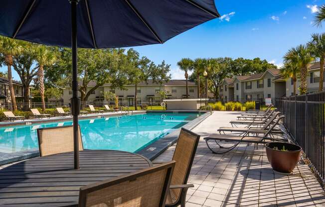 our apartments have a resort style pool with tables and chairs