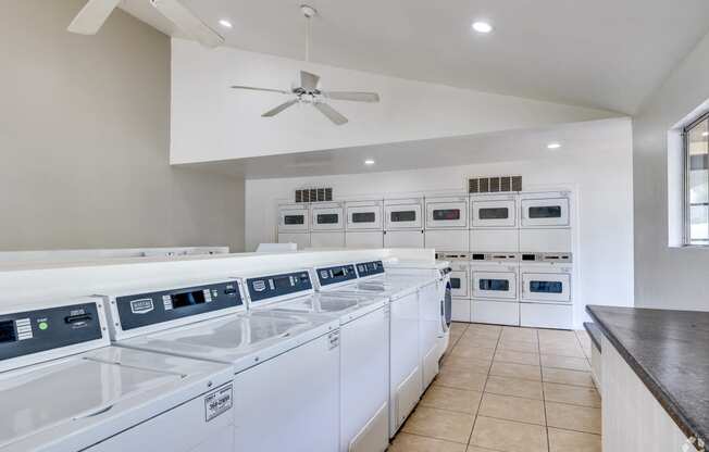 the laundry room has plenty of washes and dryers