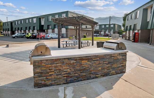 a building with a picnic area and a brick fireplace