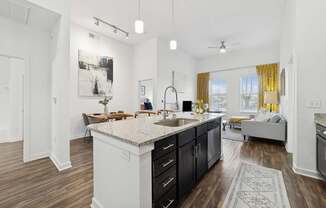A kitchen with a large island and a dining table.