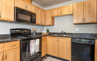 Wood cabinets and black appliance package