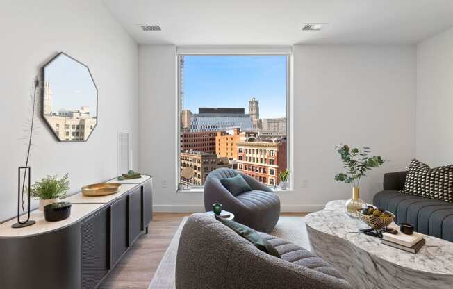 a living room with a large window overlooking the city