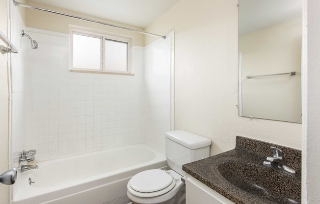 a bathroom with a sink toilet and bath tub