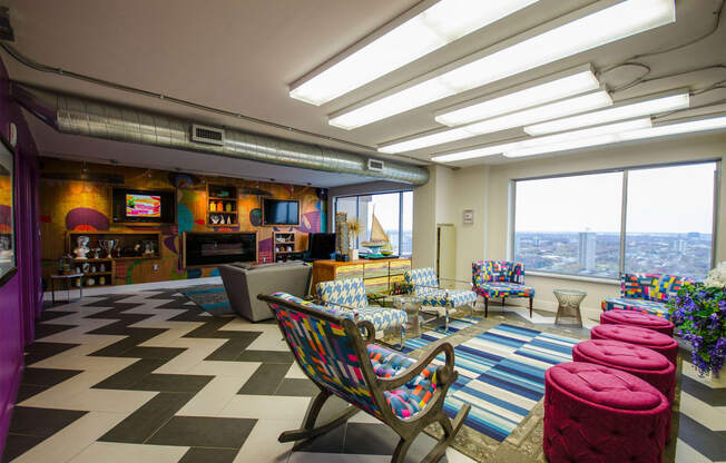 a living room with a checkered floor and tables and chairs