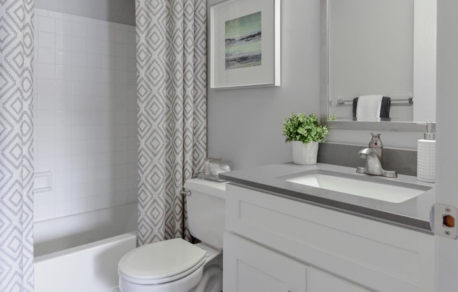 a small bathroom with a sink and toilet and a shower curtain