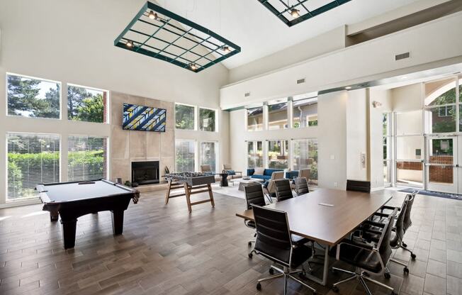 a conference room with a pool table and tables and chairs