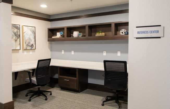 A business center with two chairs and a desk.