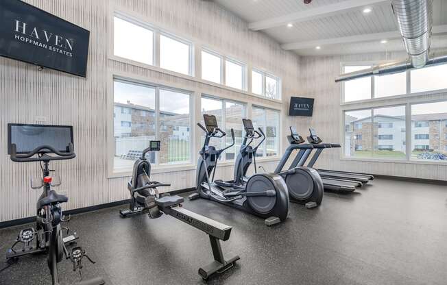 fitness center with big windows and cardio equipment