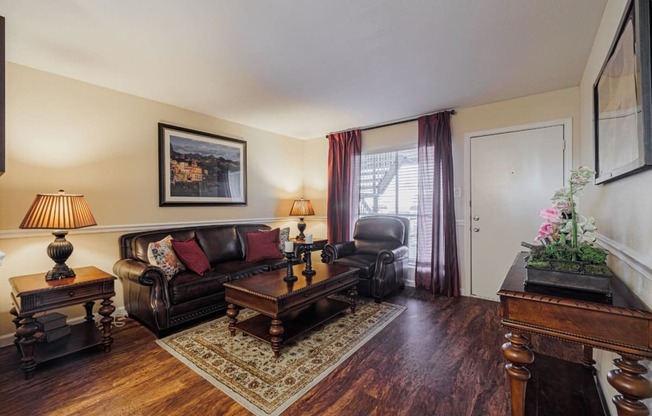 a living room with a leather couch and a coffee table